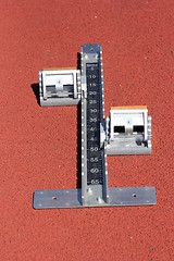 Image showing Athletics starting blocks on race red track