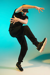 Image showing The silhouette of one hip hop male break dancer dancing on colorful background