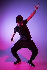 Image showing The silhouette of one hip hop male break dancer dancing on colorful background