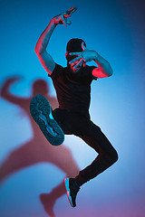 Image showing The silhouette of one hip hop male break dancer dancing on colorful background