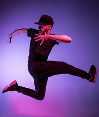 Image showing The silhouette of one hip hop male break dancer dancing on colorful background