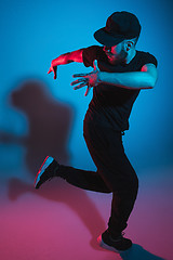 Image showing The silhouette of one hip hop male break dancer dancing on colorful background