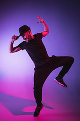 Image showing The silhouette of one hip hop male break dancer dancing on colorful background