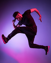 Image showing The silhouette of one hip hop male break dancer dancing on colorful background