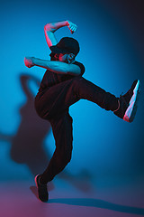 Image showing The silhouette of one hip hop male break dancer dancing on colorful background