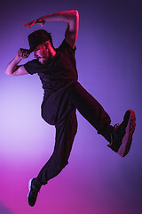 Image showing The silhouette of one hip hop male break dancer dancing on colorful background