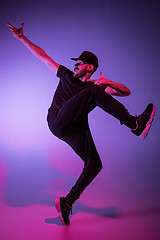 Image showing The silhouette of one hip hop male break dancer dancing on colorful background