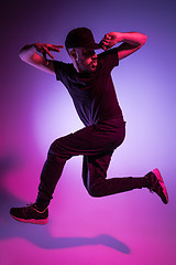 Image showing The silhouette of one hip hop male break dancer dancing on colorful background