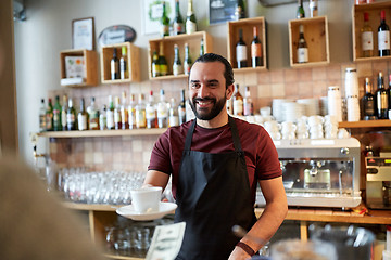 Image showing man or waiter serving customer at coffee shop