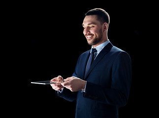 Image showing businessman in suit with transparent tablet pc