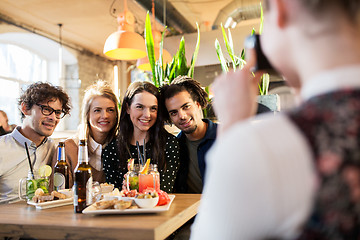 Image showing friends with camera photographing at bar or cafe