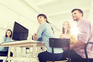 Image showing happy creative team drinking coffee at office