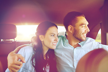 Image showing happy man and woman hugging in car