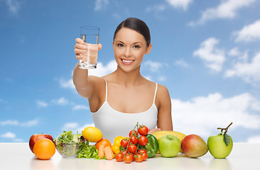 Image showing happy woman with glass of water and healthy food