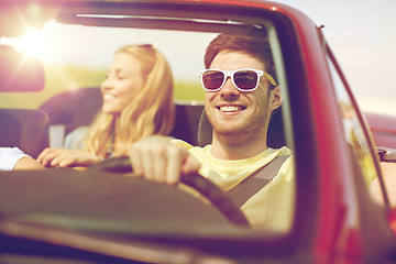 Image showing happy friends driving in cabriolet car