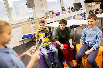 Image showing group of happy children with tablet pc at school