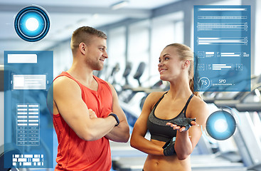 Image showing smiling man and woman talking in gym