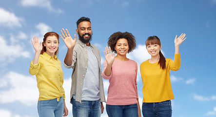 Image showing international group of happy people waving hands