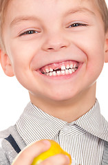 Image showing Little boy with fresh yellow apple