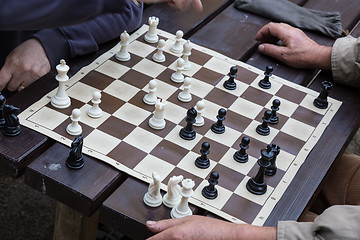 Image showing Close up of senior men playing chess.