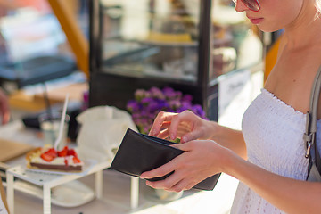 Image showing Woman buying meal at street food festival.