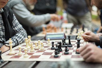 Image showing Close up of senior men playing chess.