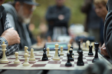 Image showing Close up of senior men playing chess.