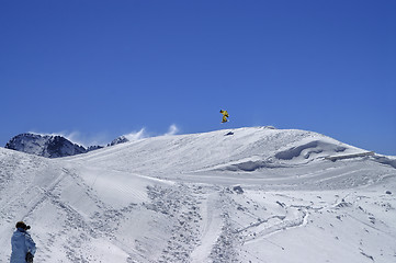 Image showing Snowboarder jumping in snow park at ski resort on sun winter day