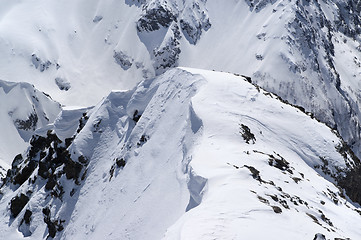 Image showing Snow cornice in high winter mountains in nice sun day