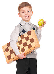Image showing Boy with chessboard and apple