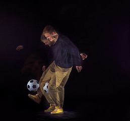 Image showing A portrait of a fan with ball on gray studio background. Freestile