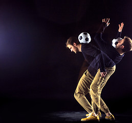 Image showing A portrait of a fan with ball on gray studio background. Freestile