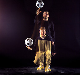 Image showing A portrait of a fan with ball on gray studio background. Freestile