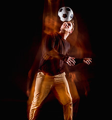 Image showing A portrait of a fan with ball on gray studio background. Freestile