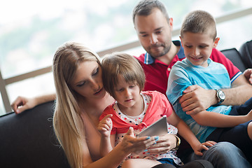 Image showing happy young couple spending time with kids