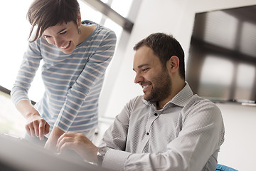 Image showing Two Business People Working With Tablet in startup office