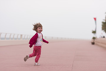 Image showing cute little girl on the promenade by the sea