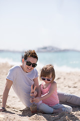 Image showing Mom and daughter on the beach