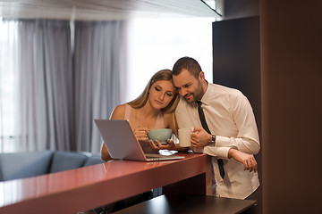 Image showing A young couple is preparing for a job and using a laptop