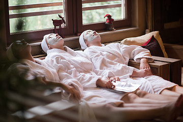 Image showing women is getting facial clay mask at spa