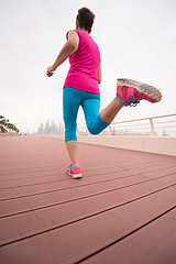 Image showing woman busy running on the promenade