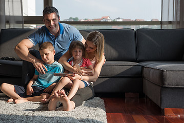 Image showing happy young couple spending time with kids