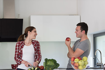 Image showing Young handsome couple in the kitchen