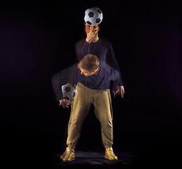 Image showing A portrait of a fan with ball on gray studio background. Freestile