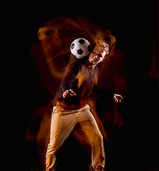 Image showing A portrait of a fan with ball on gray studio background. Freestile