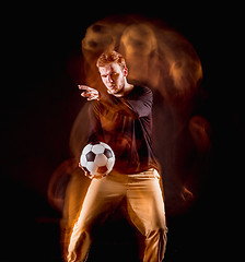 Image showing A portrait of a fan with ball on gray studio background. Freestile