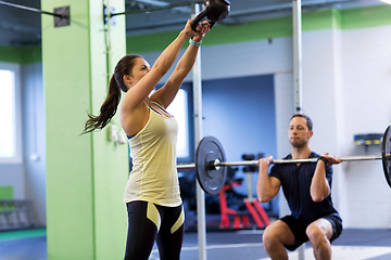 Image showing man and woman with weights exercising in gym