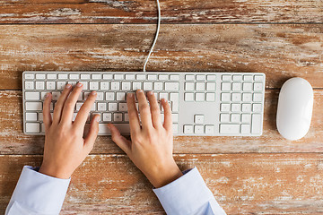 Image showing close up of hands typing on keyboard