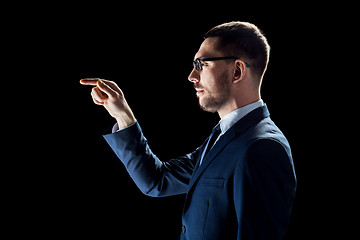 Image showing businessman in suit over black