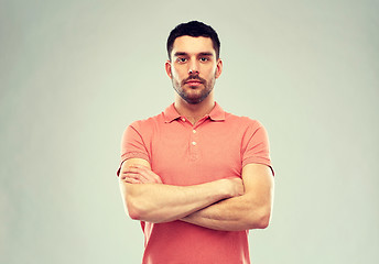 Image showing young man with crossed arms over gray background